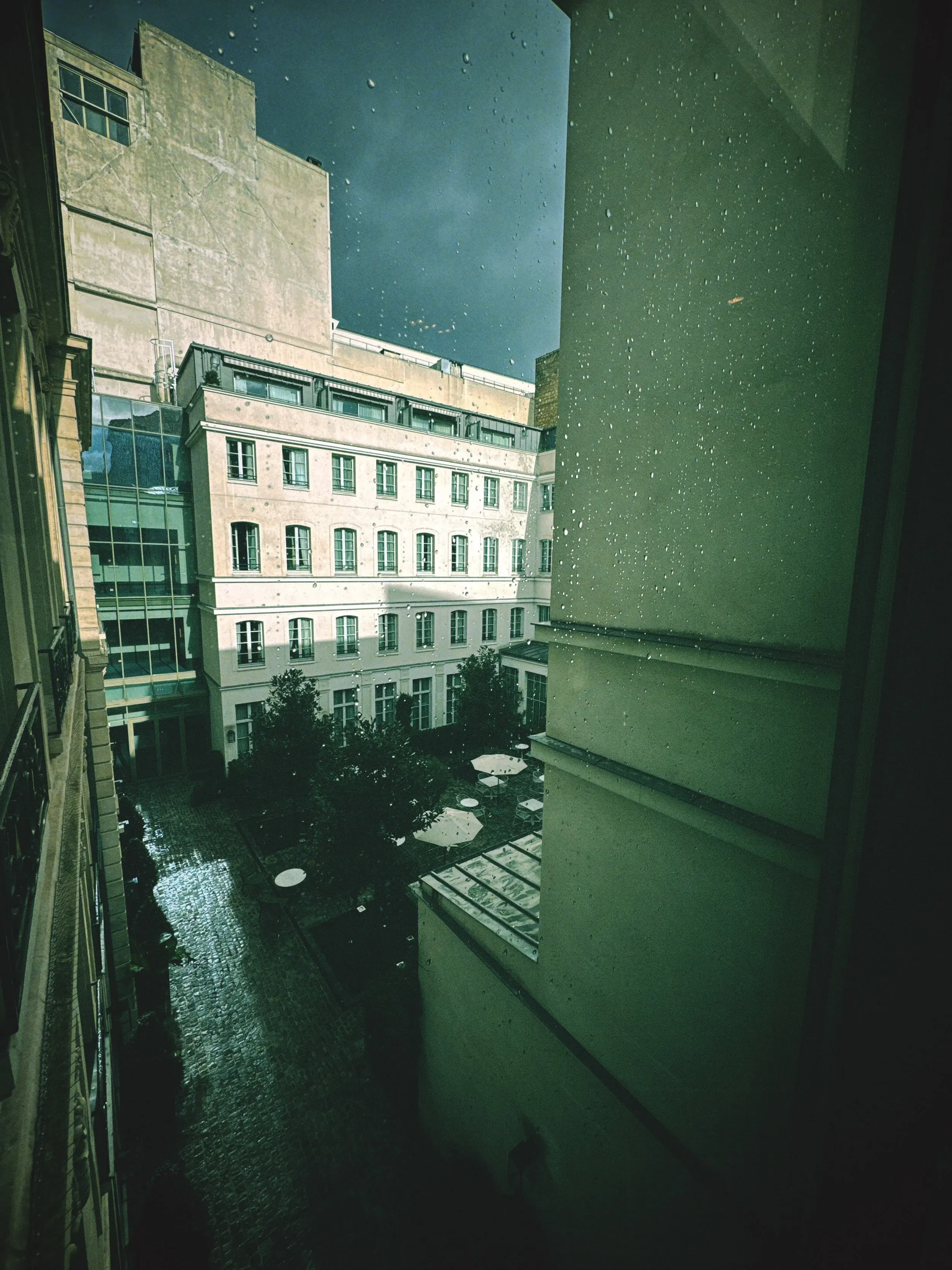 amo camera filter sample: green-toned city view through a window.